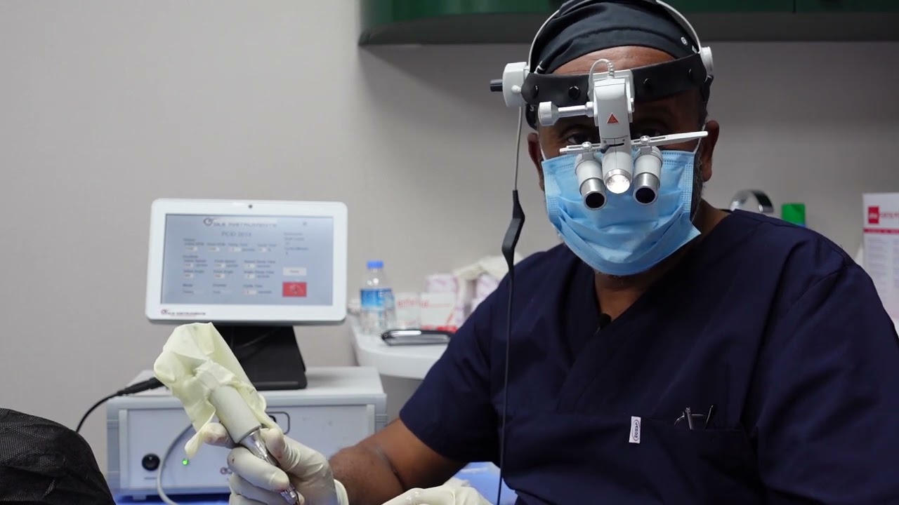Dr. Mustafa from Las Vegas with a powered FUE handpiece during his training at HTTC